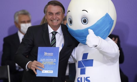 President Jair Bolsonaro with ‘Ze Gotinha’, the mascot of the nation’s vaccination campaign, during a ceremony to present Brazil’s national vaccination plan against Covid in December.