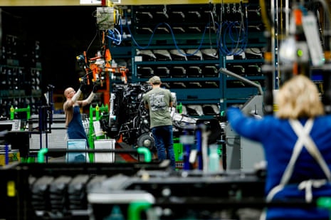 people work on a car factory assembly line