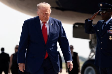 A man in a suit walks with a downcast look
