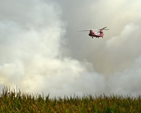 An Australian New South Wales Rural Fire Service (RFS) CH-47D Chinook water-bombing helicopter flies above the forest of Luglon during a wildfire, south-western France.
