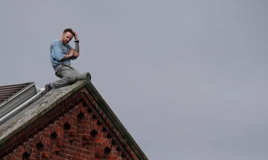 Prisoner Stuart Horner sits on the roof of Manchester’s Strangeways prison , 15 September 2015. 