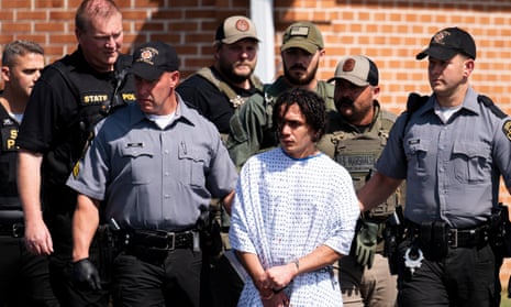 Law enforcement officers escort Danelo Cavalcante from a Pennsylvania state police barracks after his arrest.