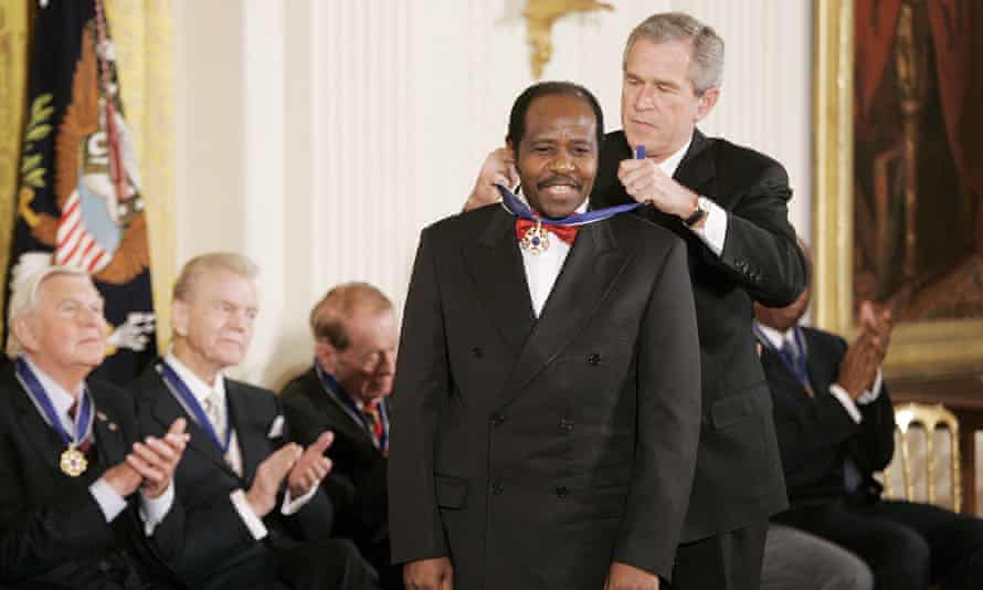 Paul Rusesabagina, the Rwandan hotelier who saved Tutsis during the genocide, is given the presidential medal of freedom by George W Bush in 2005.