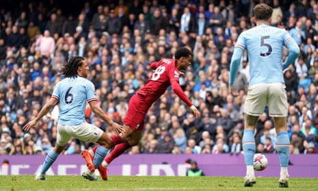 Liverpool's Cody Gakpo goes down under the challenge of Manchester City's Nathan Ake but gets no dice from the referee.