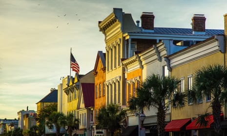 An American flag flies over the historic buildings of King Street in Charleston, South Carolina.