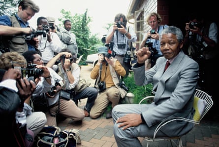 Nelson Mandela at home in Soweto, five days after his release from prison, surrounded by press photographers