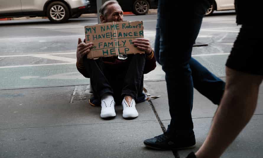 Robert, who is homeless, panhandles on a street in Manhattan.