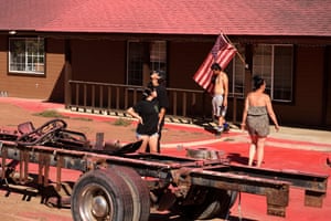 Riverside County, USPeople walk in front of a house covered in fire retardant as firefighters tackle the Juniper Fire in California
