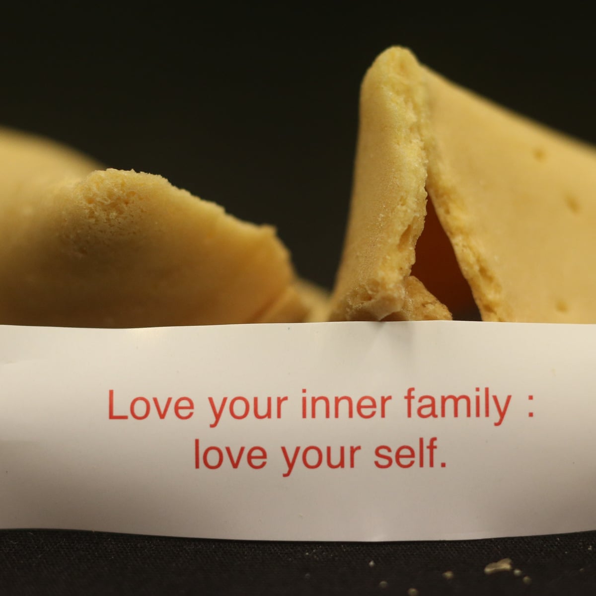 Broken fortune cookie with paper slip reading