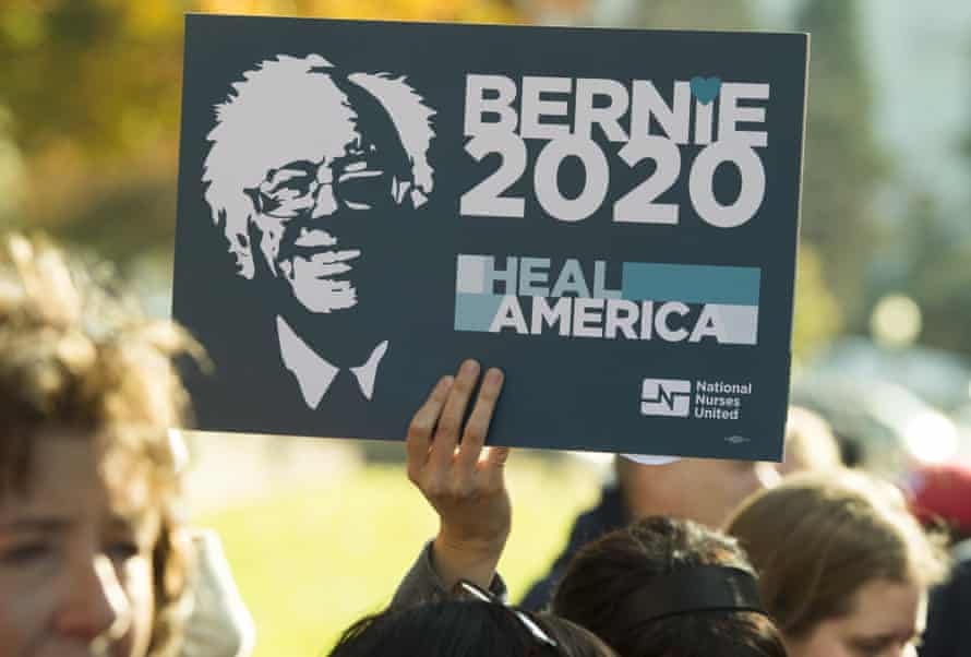 A supporter of US Senator Bernie Sanders holds up a “Bernie 2020” sign