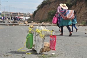 A damaged Cristo de la Concordia statuette stands in the road by a blockade set up by supporters of former president Evo Morales