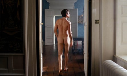 A naked man seen from behind in a grand room