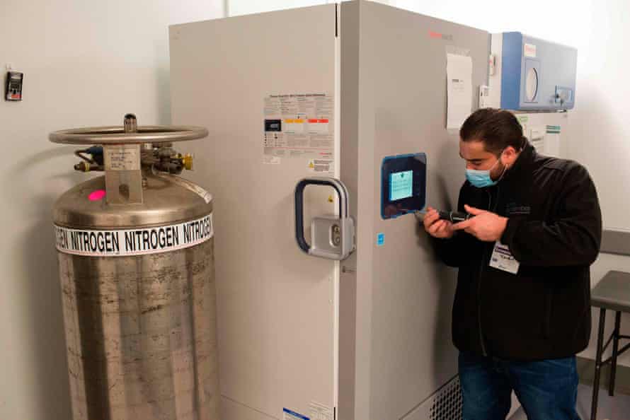 A technician is making adjustments to the vaccine freezer at Mount Sinai hospital in New York on 9 December 2020, ahead of an expected Pfizer COVID-19 vaccine shipment over the weekend. An initial shipment of 975 doses, to be stored in this freezer at -80 degrees celsius (-112 Fahrenheit), will be administered to hospital workers including ICU, ER and EMS staff.