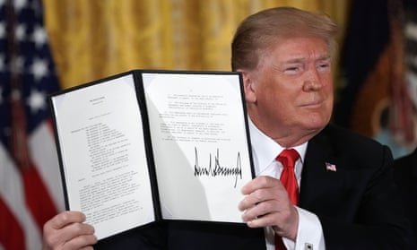 Donald Trump holds up an executive order to establish the space force, an independent and co-equal military branch.