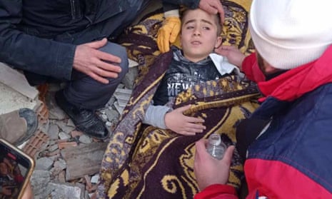 Nine-year-old Muhammed Acar after he was rescued with his seven-month-old brother Omer in Adiyaman, Turkey