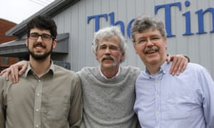 Art Cullen, centre, with his son, Tom, left, and brother, John, outside the Storm Lake Times office in Iowa after winning the Pulitzer prize