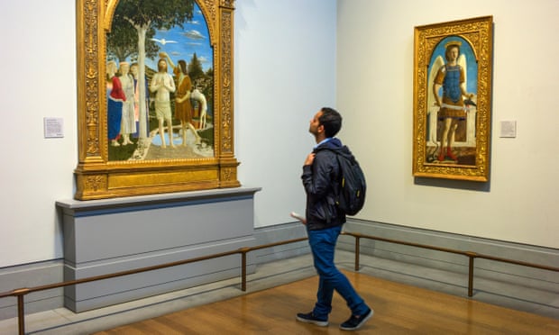 A visitor looks at Piero della Francesca’s Baptism of Christ at the National Gallery, London.