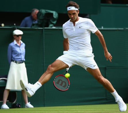 Roger Federer plays a shot through his legs at the Wimbledon tennis championships 2015