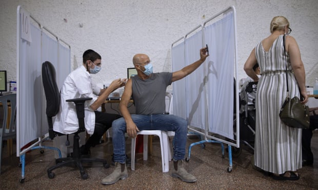 An Israeli man takes a selfie while receiving a Pfizer-BioNTech Covid-19 vaccine in Ramat Gan.