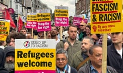 demonstrators carrying anti-racism placards