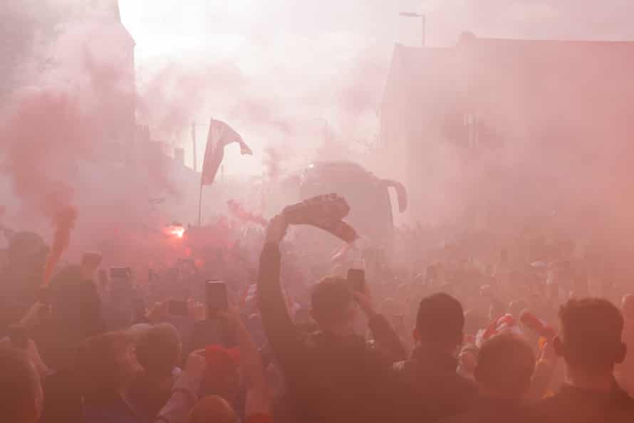 Liverpool fans cheer the arrival of the Liverpool team bus.