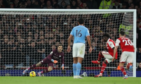 Arsenal’s Bukayo Saka scores their equaliser against Manchester City from the penalty spot.