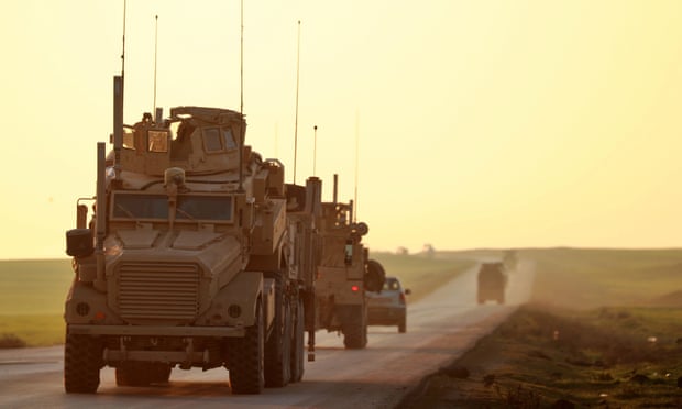 US Marine Corps tactical vehicles are seen driving along a road near Tal Baydar in Syria’s north-eastern Hasakeh province.
