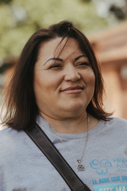 A middle-aged woman smiles.