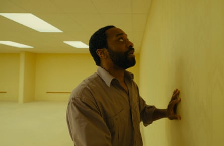 A man wearing a shirt trapped in a huge yellow room
