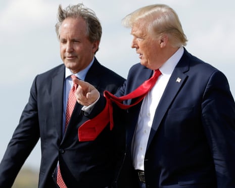 Donald Trump walks with Ken Paxton, left, at Austin-Bergstrom International Airport in Austin, Texas.
