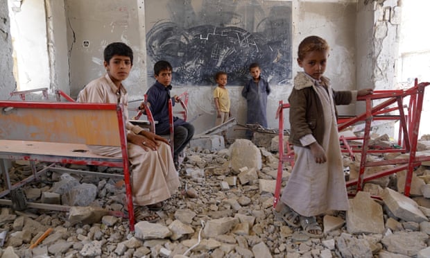 Children amid the ruins of a classroom at Aal Okab school in Sa’ada, Yemen