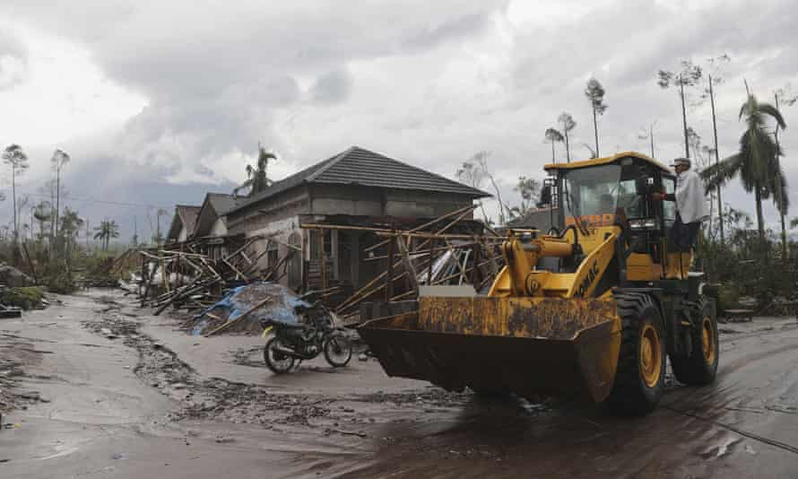 Workers clean debris on Monday in Lumajang following the eruption