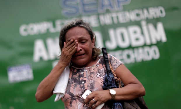 A relative of a prisoner reacts in front of the main entrance of Anísio Jobim prison in Manaus on 3 January after a riot in which 56 prisoners were butchered.