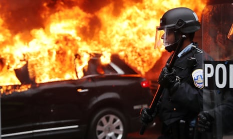 Police and demonstrators clash in downtown Washington after a limo was set on fire following Trump’s inauguration in January. 