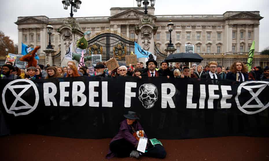 Demonstrators stand outside the gates of Buckingham Palace, during an Extinction Rebellion protest, central London