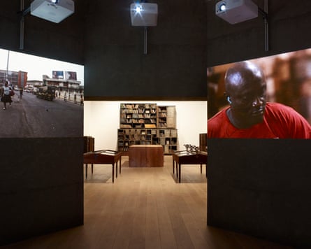 Two photographs form part of an art work. One is of a man looking down another of a street. There are chairs in the background.