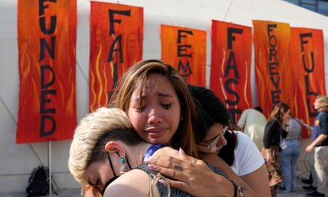 Activists hug at the end of a climate protest at the Cop28 summit