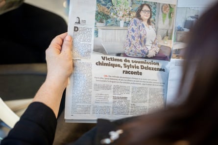 Woman reading newspaper article about case