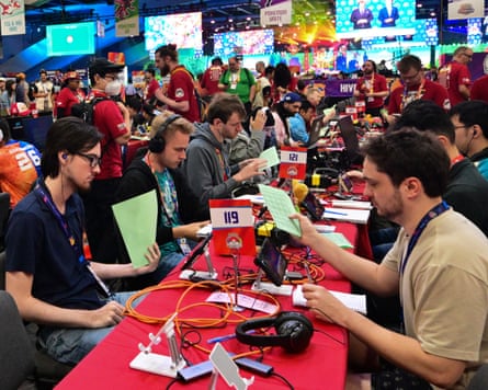 Pokémon trainers in a crowded room at the world championship.