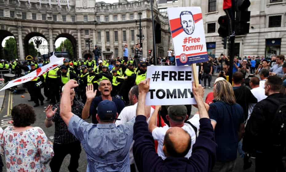Demonstrators and police at a protest against the jailing of Tommy Robinson in central London