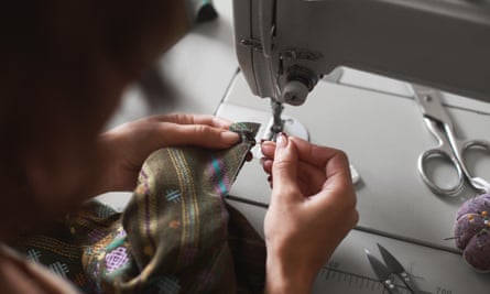 a person uses her sewing machine