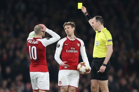 Eriksson shows Arsenal’s Nacho Monreal a yellow card.