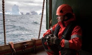 Usnea Granger, a deckhand, in waterproof clothing and helmet, by the pilot door onboard the Esperanza, in the South Orkney Islands, Antarctica