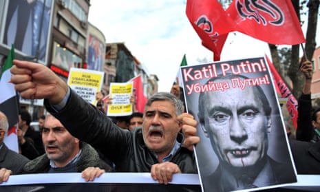 Turkish protesters in Istanbul shout anti-Russia slogans as they hold a poster of Vladimir Putin that reads ‘Assassin Putin!’