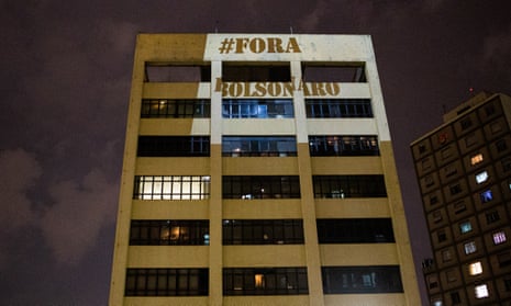 Images are projected on building walls against President of Brazil Jair Bolsonaro during a televised speech on March 18, 2020 in Sao Paulo