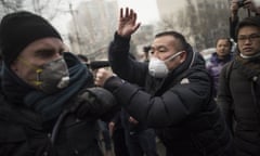 Chinese police push away journalists and supporters of human rights lawyer Pu Zhiqiang demonstrating near the Beijing Second Intermediate People’s Court in Beijing on December 14, 2015. One of China’s most celebrated human rights lawyers went on trial December 14 over online comments critical of the ruling Communist Party, as police scuffled with supporters and journalists gathered outside the courthouse. AFP PHOTO / FRED DUFOURFRED DUFOUR/AFP/Getty Images