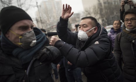 Chinese police push away journalists during the trial of Pu Zhiqiang in Beijing in December 2015. 