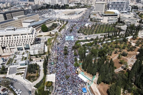 An aerial view shows protesters attending a demonstration against Israel's judicial overhaul and dismissing of the defence minister in Jerusalem.