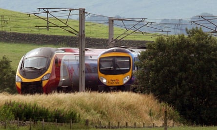 a Virgin train passing a First Group train