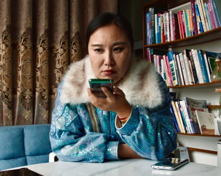 A woman wearing an embellished jacket talking into a phone